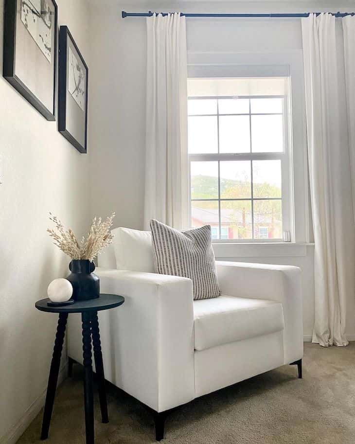 White accent chair with black side table