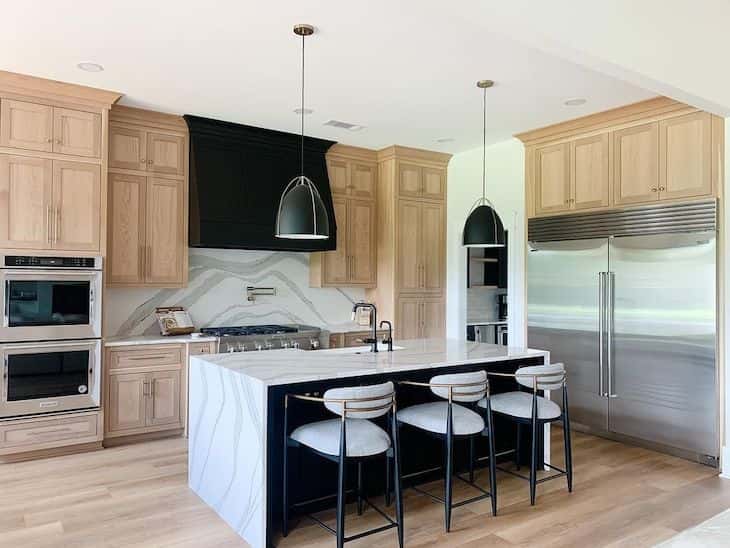 Modern farmhouse kitchen with white oak cabinets and black island