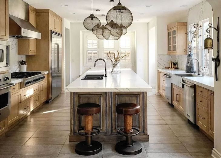 Dark stained kitchen island with light stained perimeter cabinets