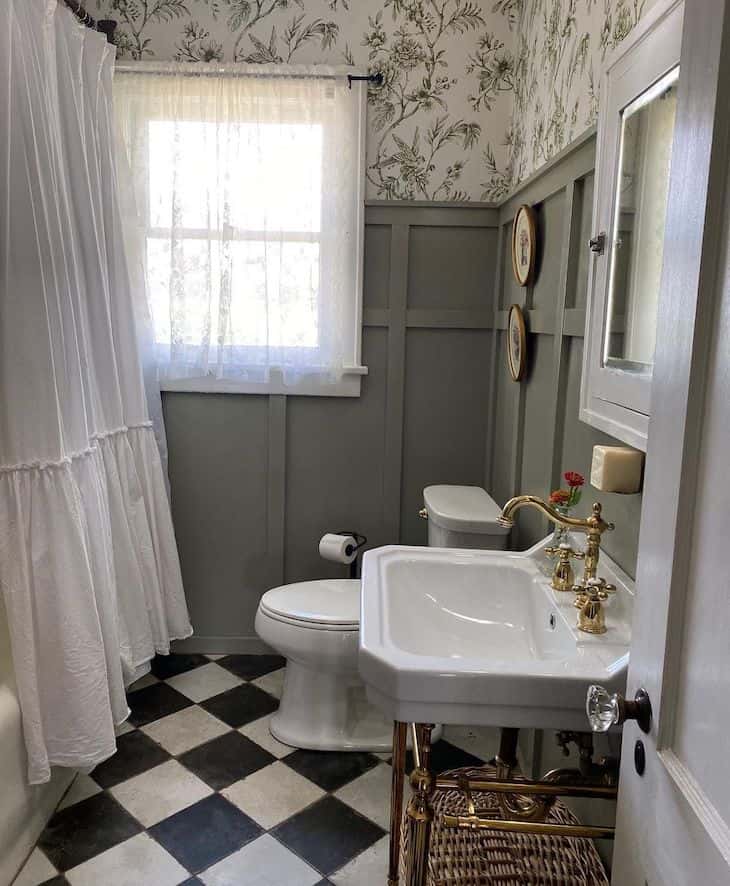 Black and white checkerboard floor tile in small bathroom