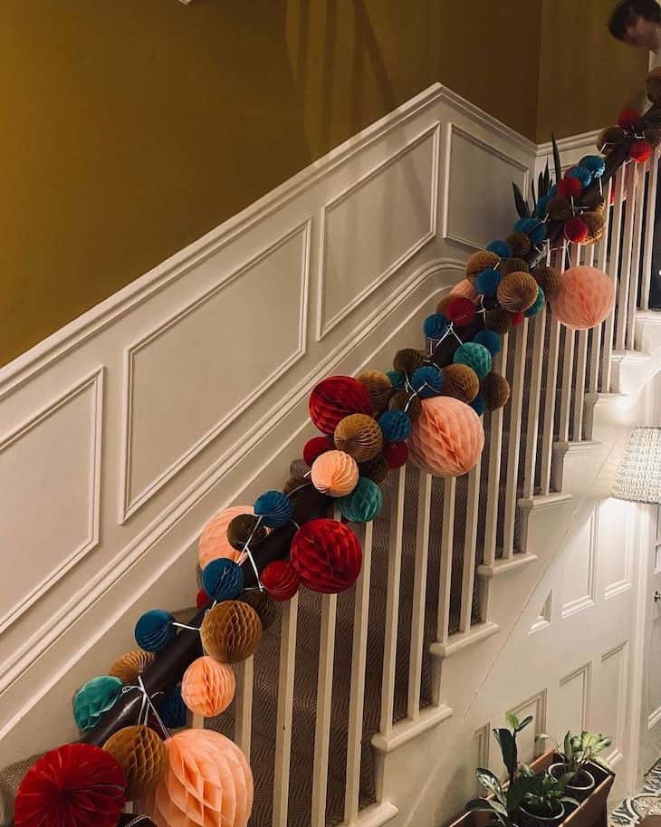 Paper honeycomb balls garland on Christmas staircase