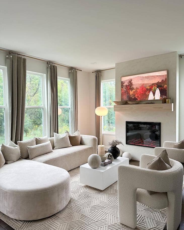 Modern White Living Room with Taupe Sofas and Sculptural Accent Chairs
