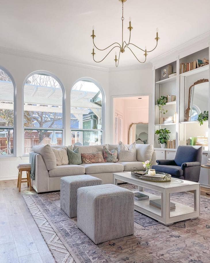 Cozy White Living Room with Pastel Pillows and Layered Textures