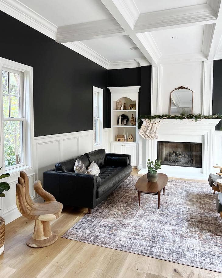 living room with black leather sofa