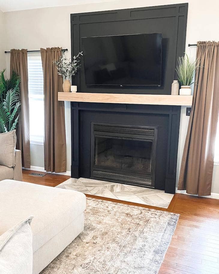 Black Fireplace with Natural Wood Mantel