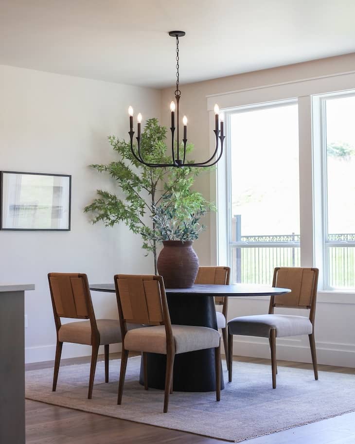 Black Round Pedestal Table With Mid-Century Chairs