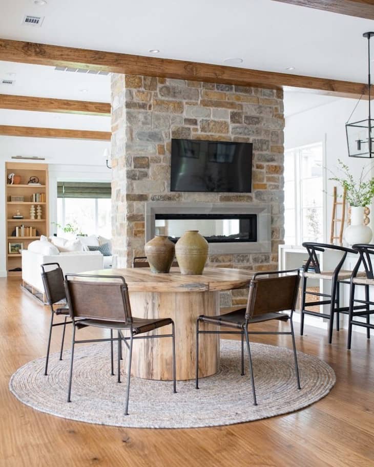 Round Rustic Wood Table With Simple Metal Chairs