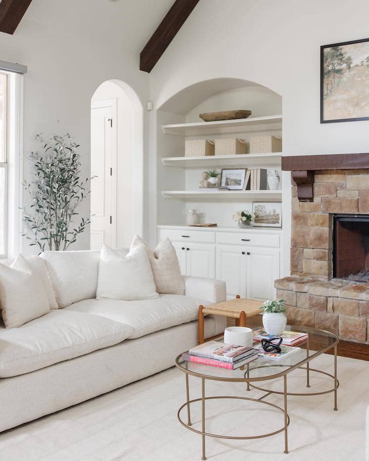 Arched White Built-Ins with Stone Fireplace