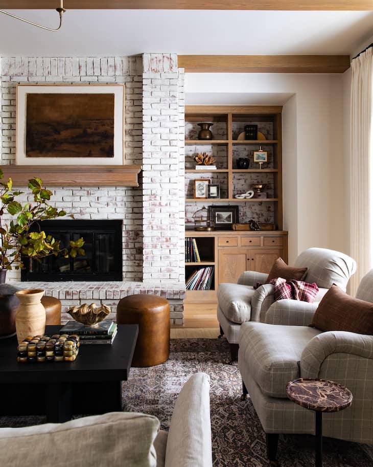 Whitewashed Brick Fireplace with Rustic Wood Built-Ins