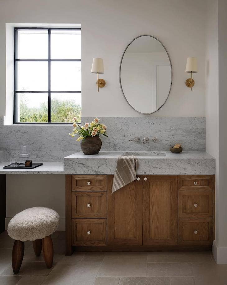 Marble Vanity With Warm Wood Cabinets