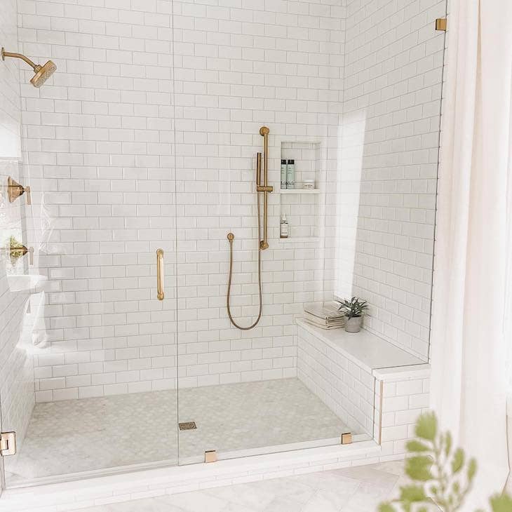 Classic White Subway Tile Shower With Brass Accents